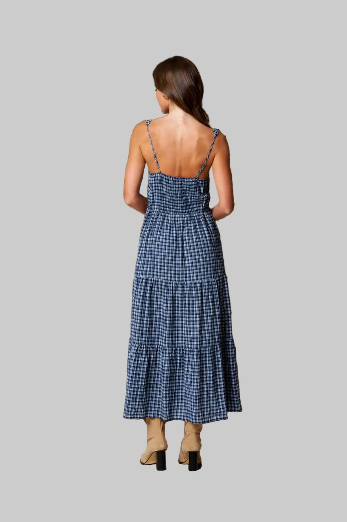Woman in a blue checkered Maxi dress grey background