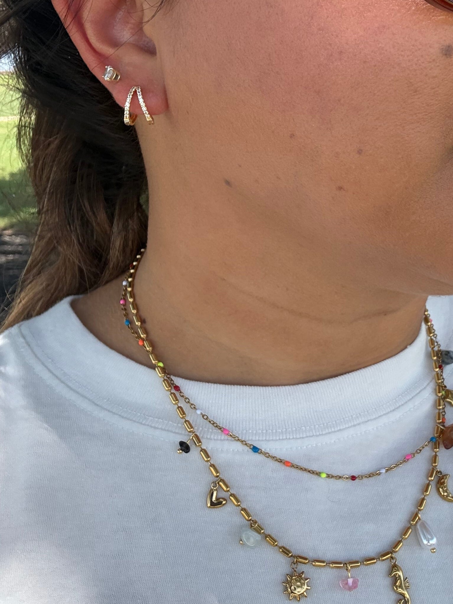 Gold double Huggie hoops paired with a double chained charm ocean sea necklace bright colors stones pearls 