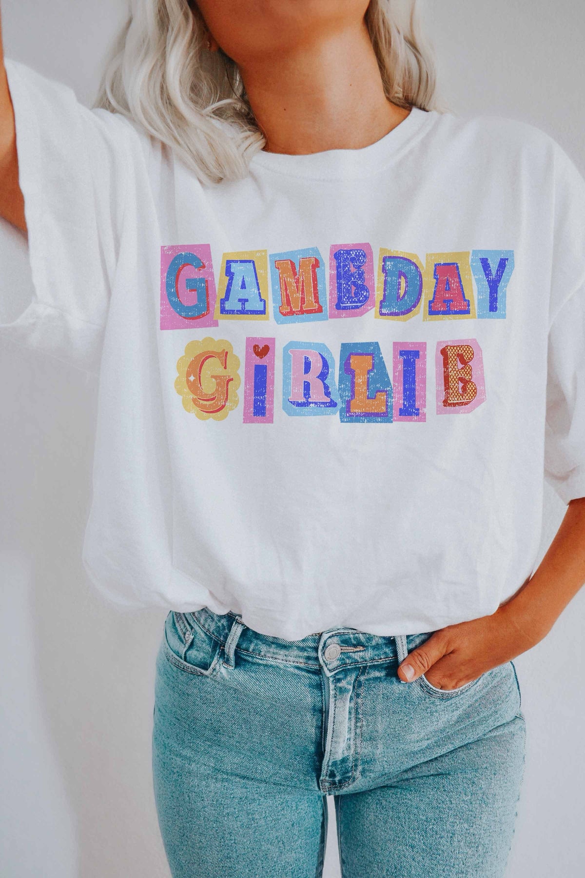 Woman wearing a white oversized game day girlie oversized tee