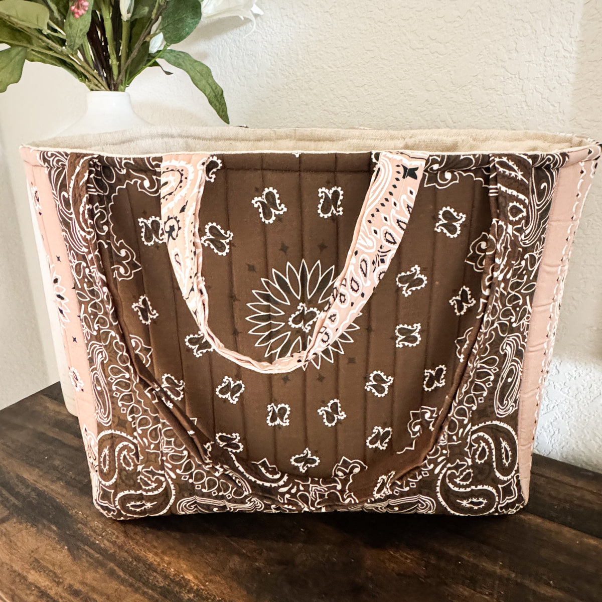 Quilted paisley-patterned tote bag in brown and cream.