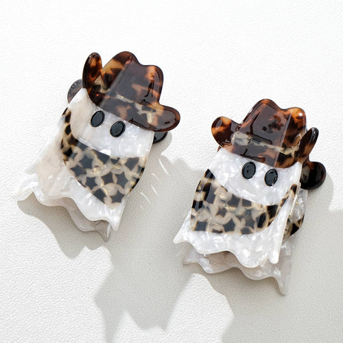 Two ghost-shaped hair clips with tortoiseshell accents on a white background