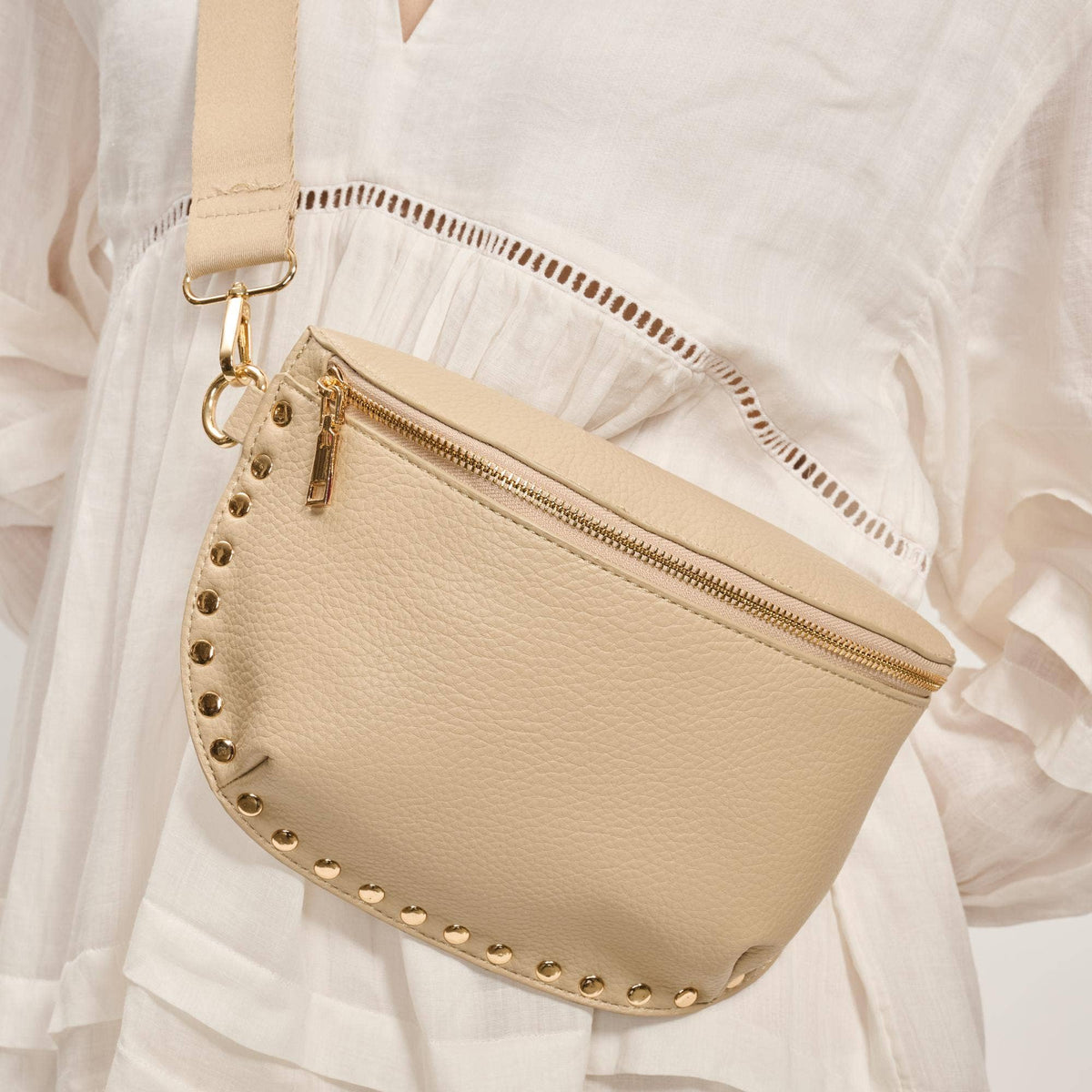 Beige handbag with gold accents on a white background