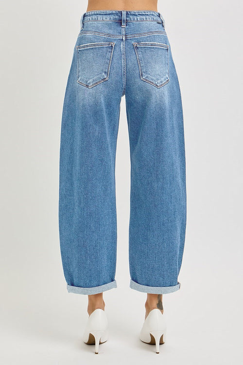 Blue jeans worn by a person on a white background