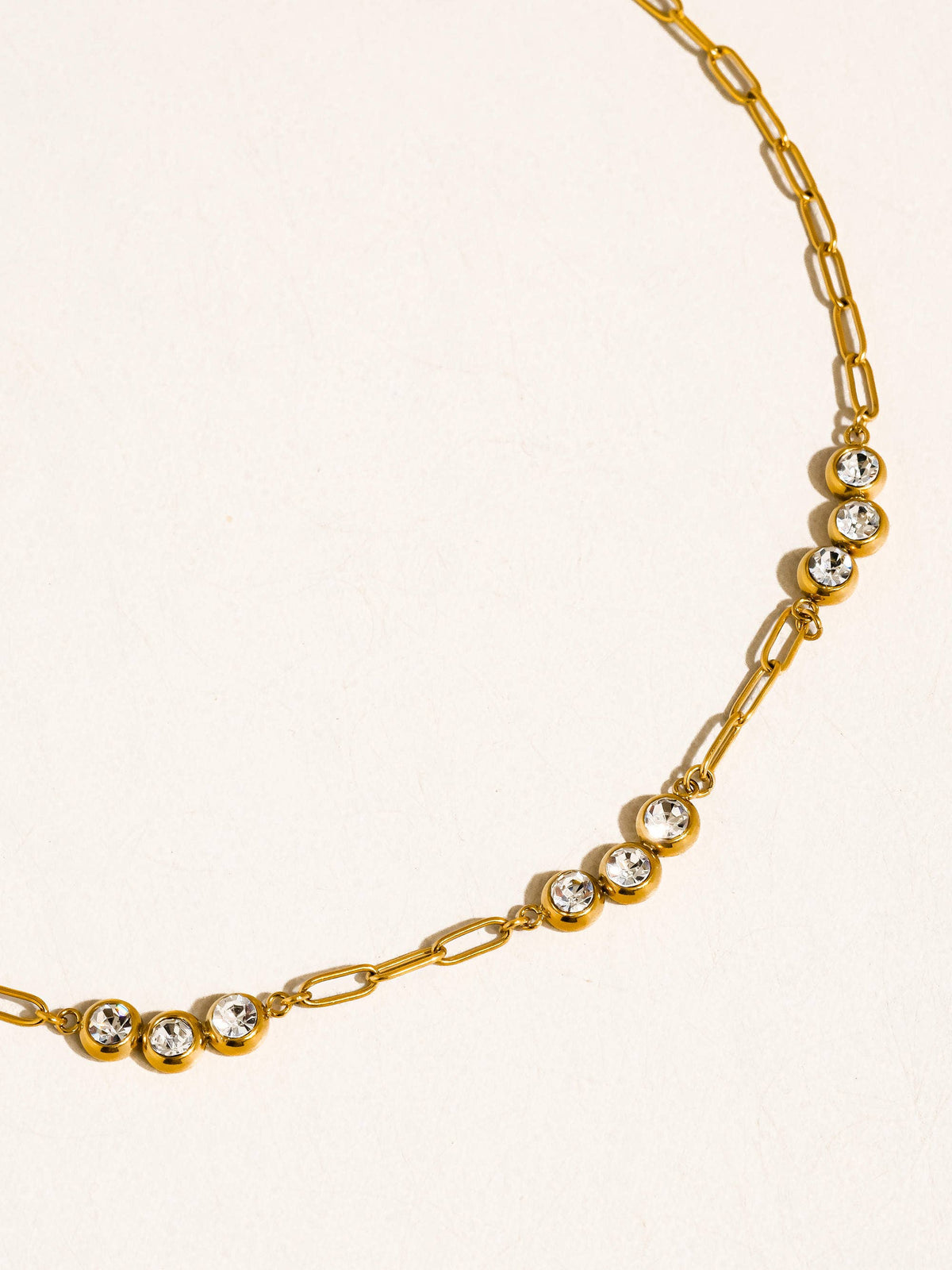 Gold-plated chain necklace with cubic zirconia details.